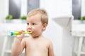 Adorable child learing how to brush his teeth