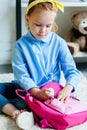 adorable child packing pink school bag