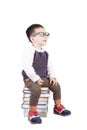 Adorable child studying with books and wearing glasses