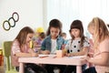 Adorable children drawing together at table. Kindergarten playtime activities Royalty Free Stock Photo