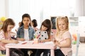 Adorable children drawing together at table. Kindergarten playtime activities Royalty Free Stock Photo