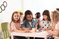 Adorable children drawing together at table. Kindergarten playtime activities Royalty Free Stock Photo