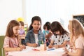 Adorable children drawing together at table. Kindergarten playtime activities Royalty Free Stock Photo