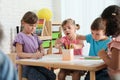 Adorable children drawing together at table. Kindergarten playtime activities Royalty Free Stock Photo