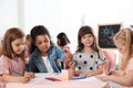 Adorable children drawing together at table. Kindergarten playtime activities Royalty Free Stock Photo