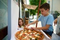 Adorable children eating delicious freshly baked Italian Margherita pizza with crispy crust in the street Royalty Free Stock Photo