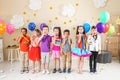 Adorable children with party blowers indoors Royalty Free Stock Photo
