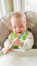 Adorable Chinese Caucasian Baby Boy Playing With His Spoon