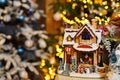Adorable christmas music toy house with miniature santa presents decorated tree bokeh background