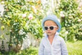 Adorable cool child boy in sunglasses oudoor. Kids fashion. Boss children.
