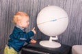 Adorable curious baby boy with a globe Royalty Free Stock Photo