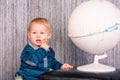 Adorable curious baby boy with a globe Royalty Free Stock Photo