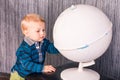 Adorable curious baby boy with a globe Royalty Free Stock Photo