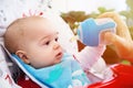 Adorable Curious baby drinks water from the bottle