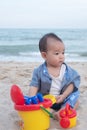 Adorable  Cute Asian baby boy playing with beach toys on tropical beach Royalty Free Stock Photo