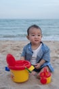 Adorable  Cute Asian baby boy playing with beach toys on tropical beach Royalty Free Stock Photo