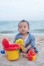 Adorable Cute  Asian baby boy playing with beach toys on tropical beach Royalty Free Stock Photo