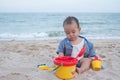 Adorable  Cute Asian baby boy playing with beach toys on tropical beach Royalty Free Stock Photo