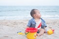 Adorable  Cute Asian baby boy playing with beach toys on tropical beach Royalty Free Stock Photo