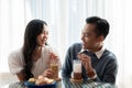 Adorable cute Asian couple having a lovely date at a cafe, having food and drinks