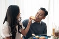 Adorable cute Asian couple having a lovely date at a cafe, having food and drinks