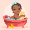 Adorable, cute baby in the bathtub with bubbles hugs the soap bar