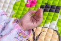 Adorable cute baby girl`s palm of left-hand and fingers close up macro photography, three weeks old infant. Dressed in beautiful