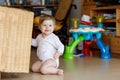 Adorable cute beautiful little baby girl playing with educational toys at home or nursery. Royalty Free Stock Photo