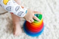 Adorable cute beautiful little baby girl playing with educational wooden toys at home or nursery. Toddler with colorful Royalty Free Stock Photo