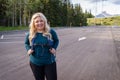 Adorable cute blonde young adult woman is ready for a hike - taken at Troll Falls parking lot in Kananaskis Country Canada