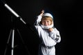 Adorable cute boy astronaut in outer space. Child imagines himself to be an astronaut in an astronauts helmet. Portrait