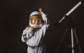 Adorable cute boy astronaut in outer space. Child imagines himself to be an astronaut in an astronauts helmet. Portrait