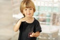 Happy kid eating grapes in light room