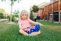 Adorable cute happy Caucasian girl holding Australian flag. Smiling child sitting on grass in park holding Australia flag. Kid Royalty Free Stock Photo