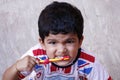 Adorable cute indian baby boy with colorful shirt doing morning brushing the teeth Royalty Free Stock Photo