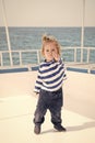 Little baby captain on boat on summer cruise, nautical fashion Royalty Free Stock Photo