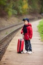 Adorable cute little child, boy, waiting on a railway station fo Royalty Free Stock Photo