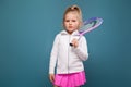 Adorable cute little girl in white shirt, white jacket and pink skirt with tennis racket Royalty Free Stock Photo