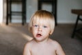 Adorable Cute Little Long Blonde Haired Blue Eyed Toddler Kid Boy Face Expressions Head Shots at Home Playing with Mom