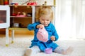 Adorable cute little toddler girl playing with toy kitchen Happy healthy baby child having fun with role game, playing Royalty Free Stock Photo