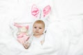 Adorable cute newborn baby girl in Easter bunny costume and ears. Royalty Free Stock Photo