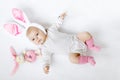 Adorable cute newborn baby girl in Easter bunny costume and ears. Royalty Free Stock Photo