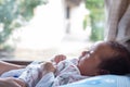 The adorable cute newborn baby infant with big black eyes lying on the bed Royalty Free Stock Photo