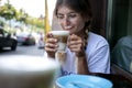 Cute pretty young woman drinks coffee milk foam Royalty Free Stock Photo