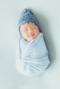 Asian newborn baby with blue knitted hat sleeping Royalty Free Stock Photo