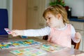 Adorable cute toddler girl playing picture card game. Happy healthy child training memory, thinking. Creative indoors Royalty Free Stock Photo