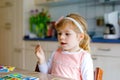 Adorable cute toddler girl playing picture card game. Happy healthy child training memory, thinking. Creative indoors Royalty Free Stock Photo