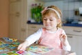 Adorable cute toddler girl playing picture card game. Happy healthy child training memory, thinking. Creative indoors Royalty Free Stock Photo