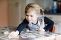 Adorable cute toddler girl playing picture card game. Happy healthy child training memory, thinking. Creative indoors Royalty Free Stock Photo