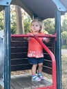 Adorable cute toddler girl walking in a park on autumn day. Happy child having fun outdoors. Autumnal activities with Royalty Free Stock Photo